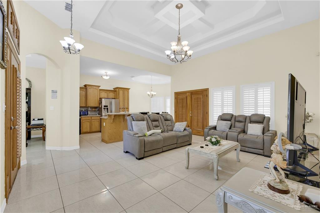305 North 15th Street Hidalgo, TX 78557 - Photo 8 of 28 a living room with furniture a dining table and a chandelier