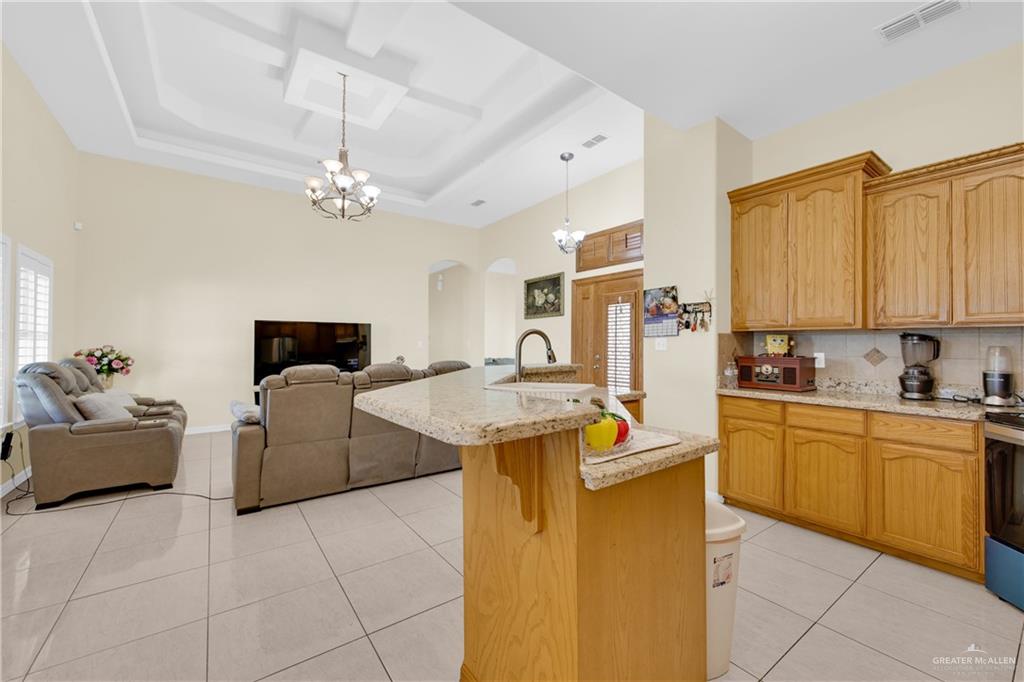 305 North 15th Street Hidalgo, TX 78557 - Photo 10 of 28 a kitchen with stainless steel appliances granite countertop a sink and cabinets