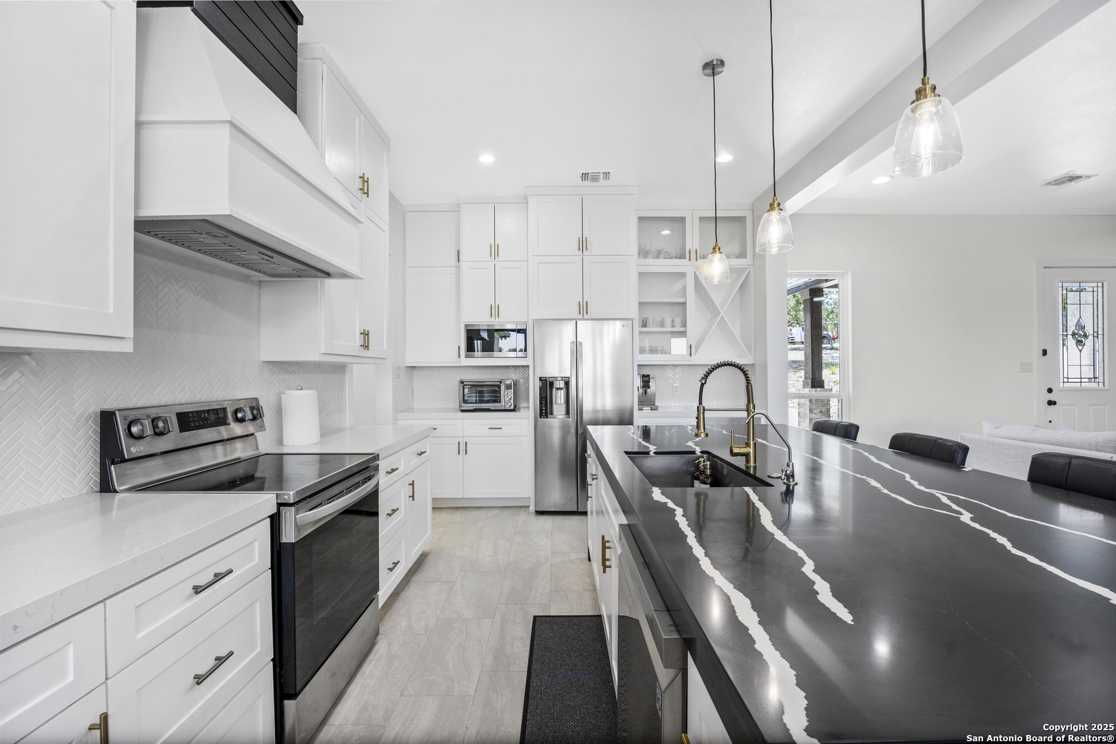 1101 Persimmon Pass Fischer, TX 78623 - Photo 16 of 43 a kitchen with stainless steel appliances granite countertop a sink a stove and refrigerator