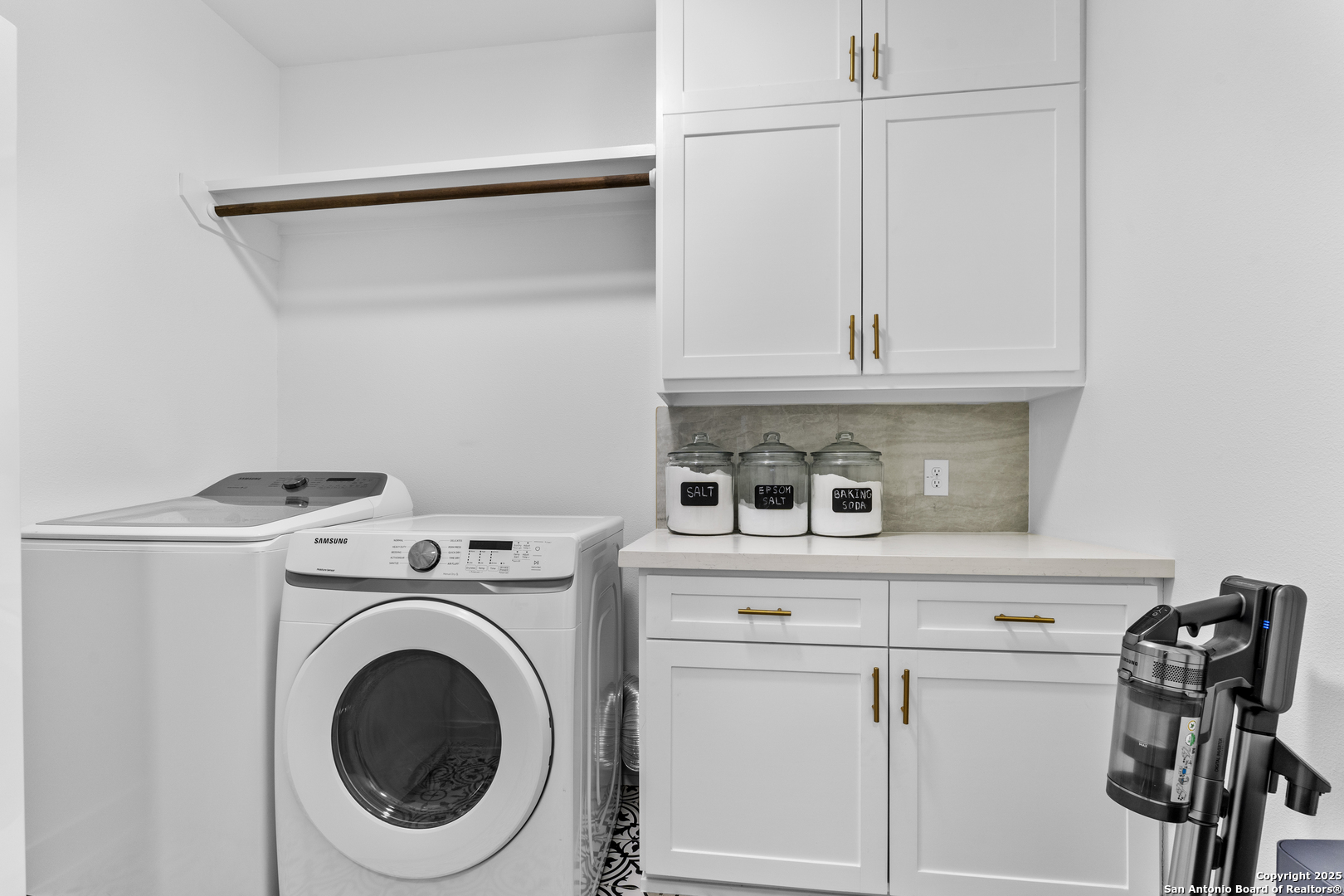1101 Persimmon Pass Fischer, TX 78623 - Photo 19 of 43 a view of washer and dryer with kitchen in the background