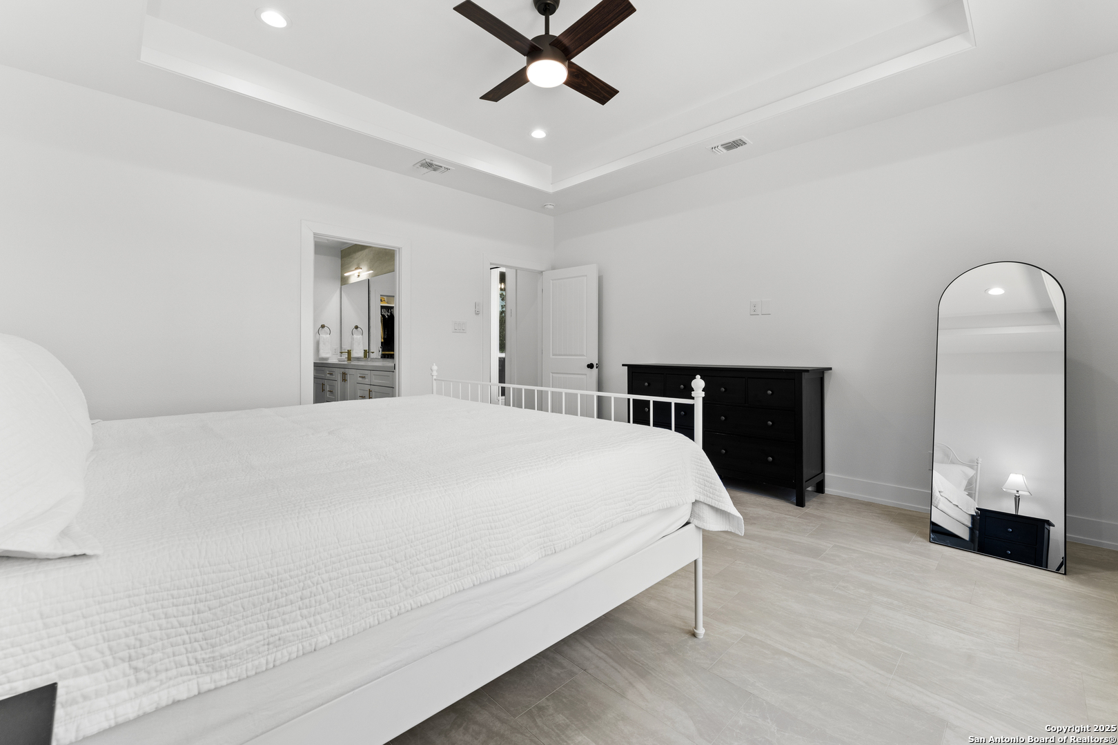 1101 Persimmon Pass Fischer, TX 78623 - Photo 24 of 43 a spacious bedroom with a bed and a chandelier