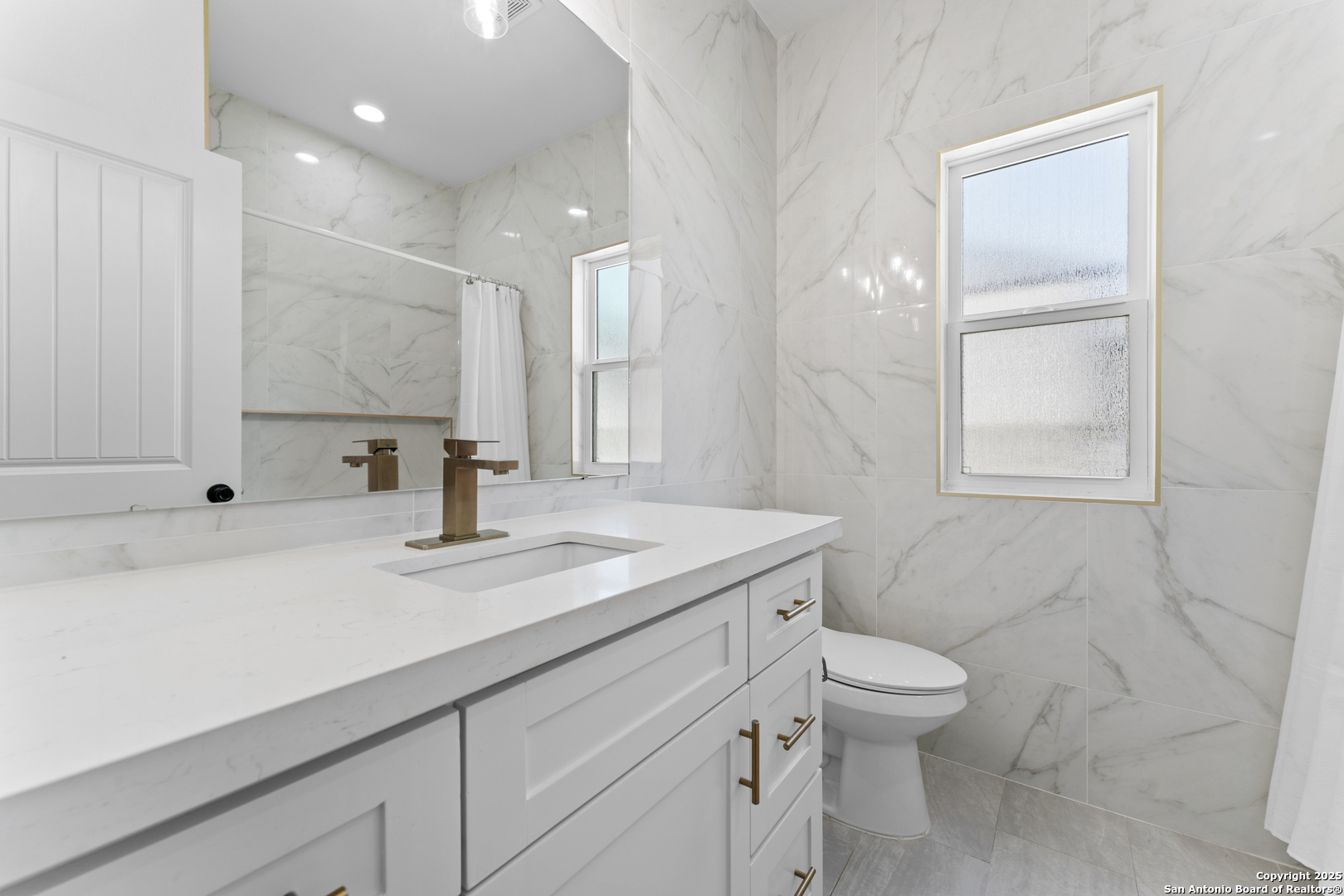 1101 Persimmon Pass Fischer, TX 78623 - Photo 29 of 43 a bathroom with a sink a toilet and a large mirror
