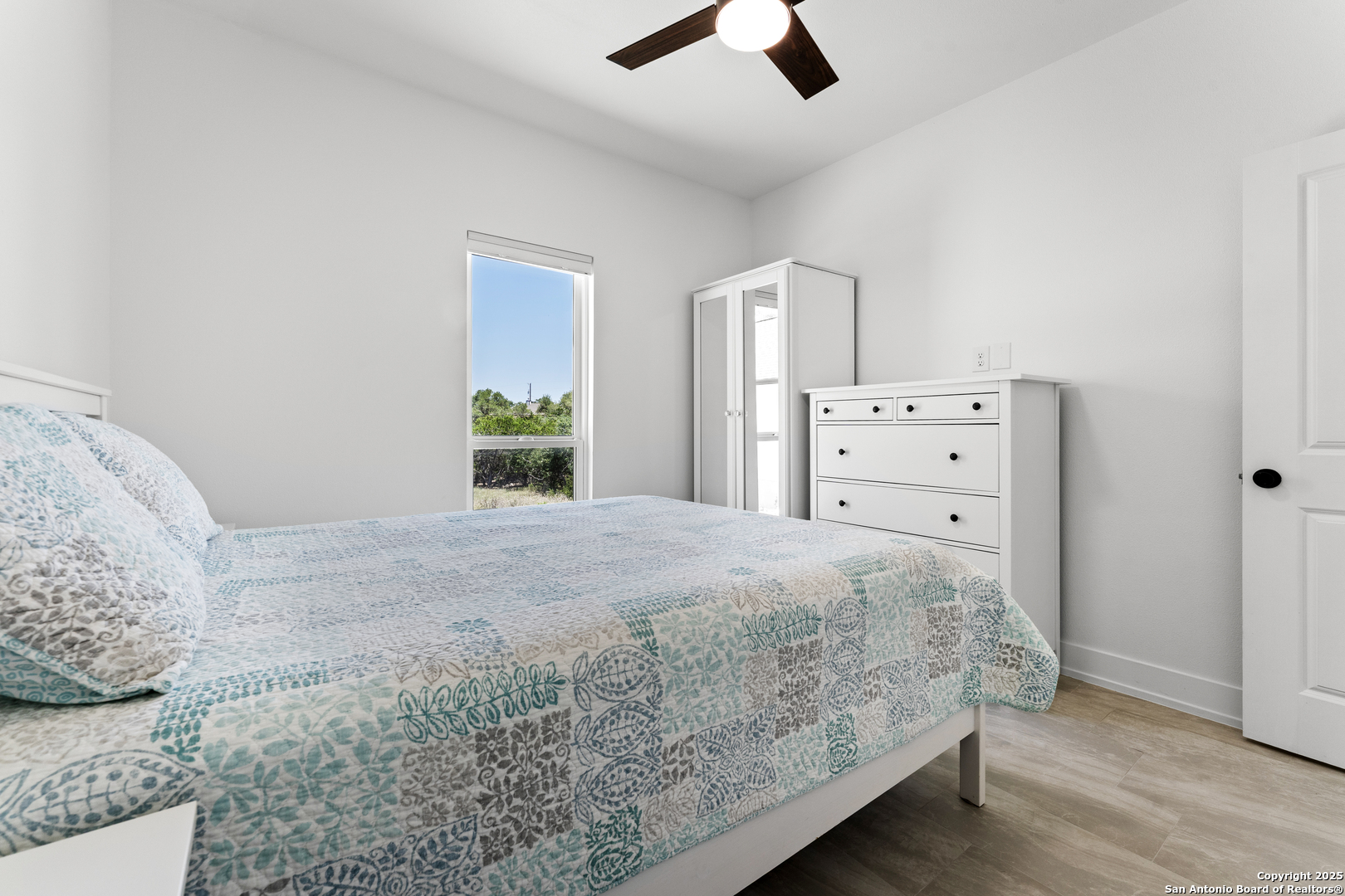 1101 Persimmon Pass Fischer, TX 78623 - Photo 31 of 43 a bedroom with a bed and wooden floor