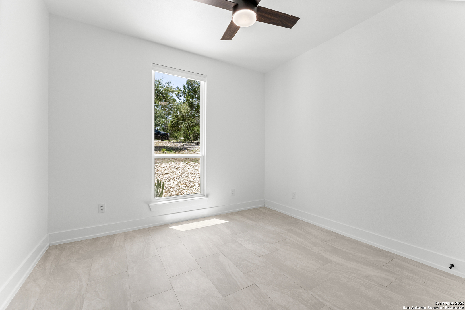 1101 Persimmon Pass Fischer, TX 78623 - Photo 34 of 43 an empty room with windows and fan