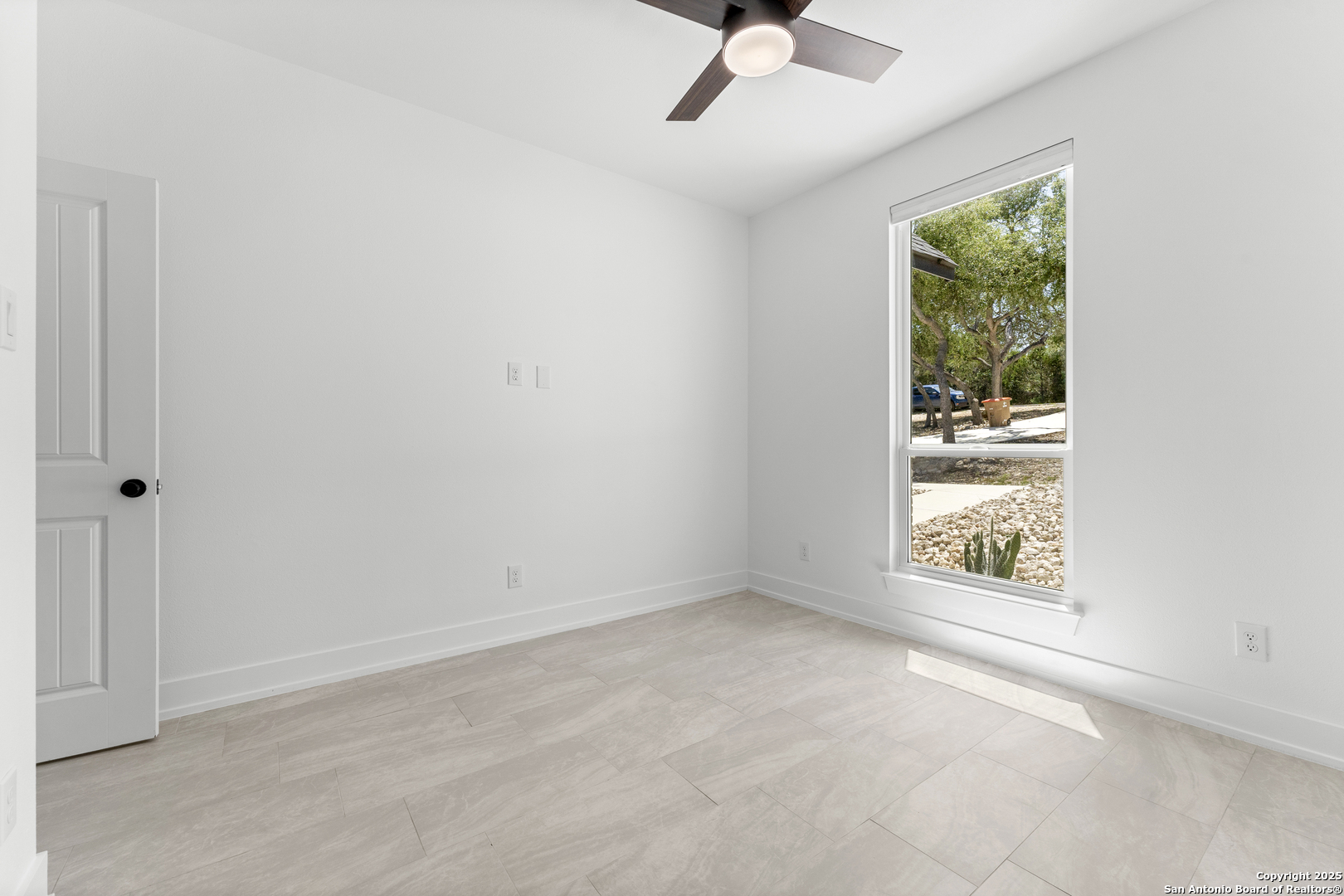 1101 Persimmon Pass Fischer, TX 78623 - Photo 35 of 43 an empty room with windows and fan