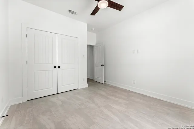 a balcony with furniture and a potted plant
