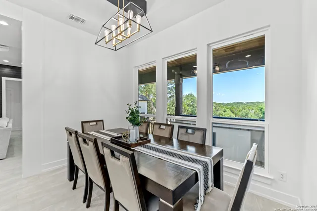 a dining room with furniture and window