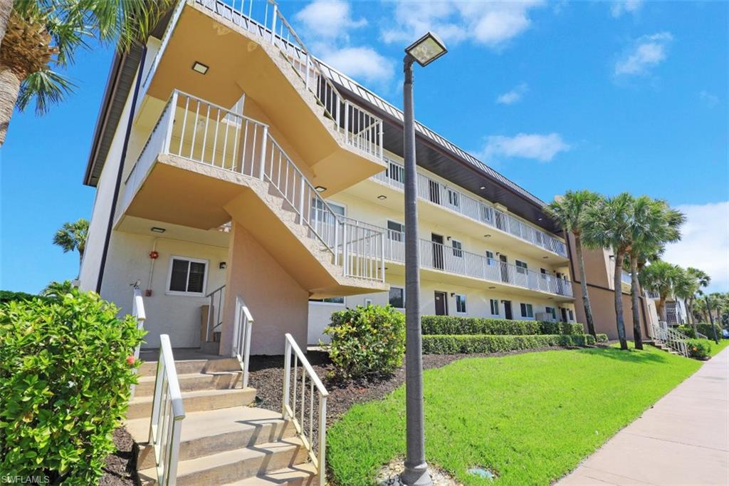 1004 Manatee Road, Unit H301 Naples, FL 34114 - Photo 2 of 33 a front view of a house with a yard