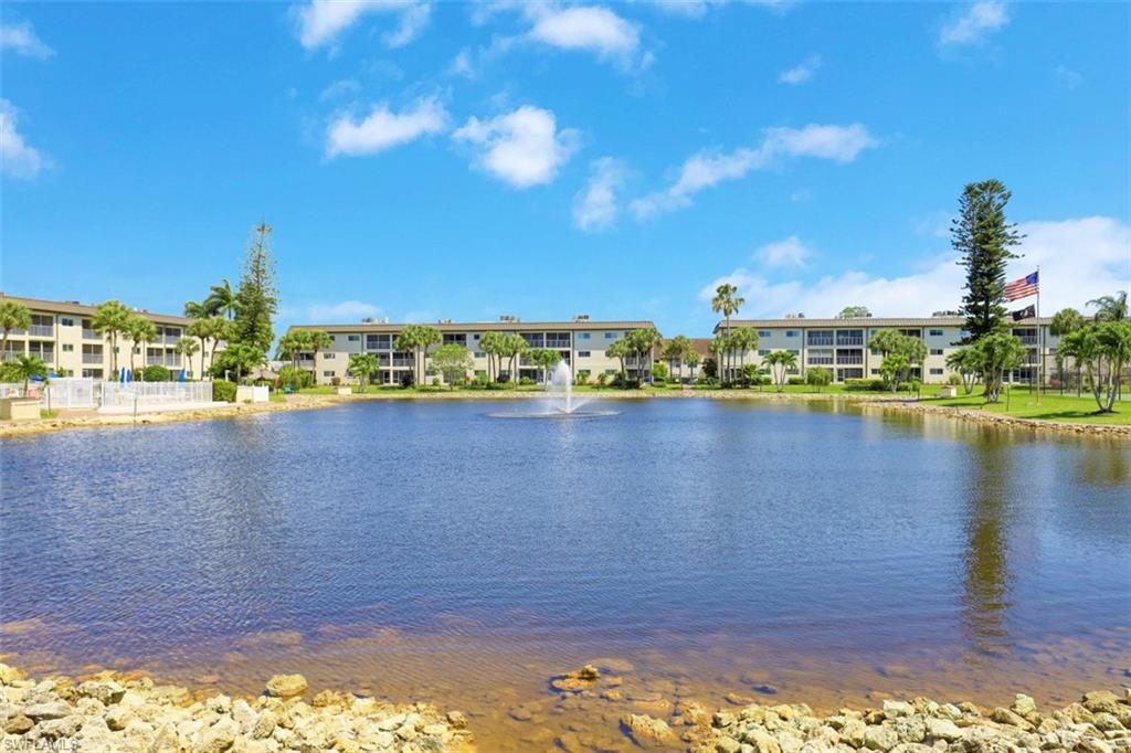 1004 Manatee Road, Unit H301 Naples, FL 34114 - Photo 27 of 33 a view of a lake with houses in the back