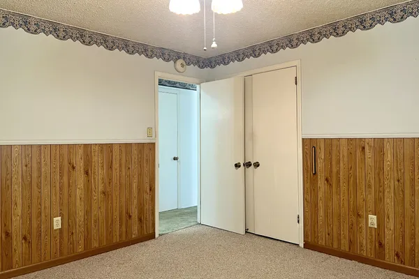 a view of a livingroom with a ceiling fan and window