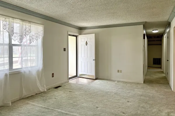 an empty room with windows and closet