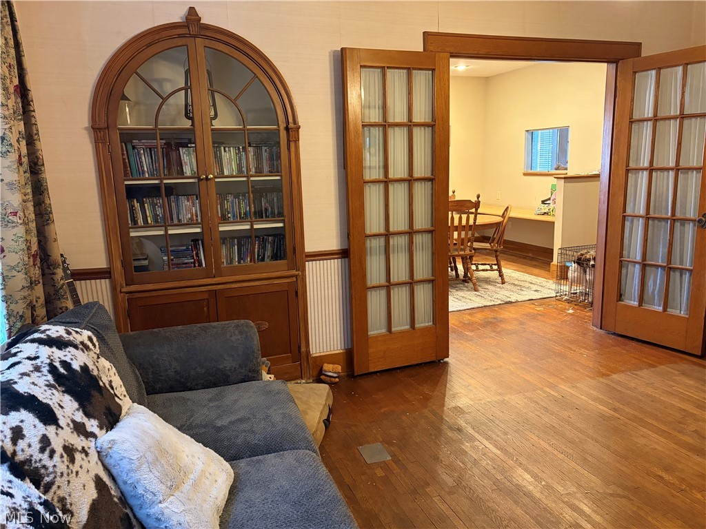 2031 Ridgewood Avenue Alliance, OH 44601 - Photo 4 of 22 DINING ROOM WITH GLASS DOORS, BUILT IN HUTCH AND WOOD FLOORING