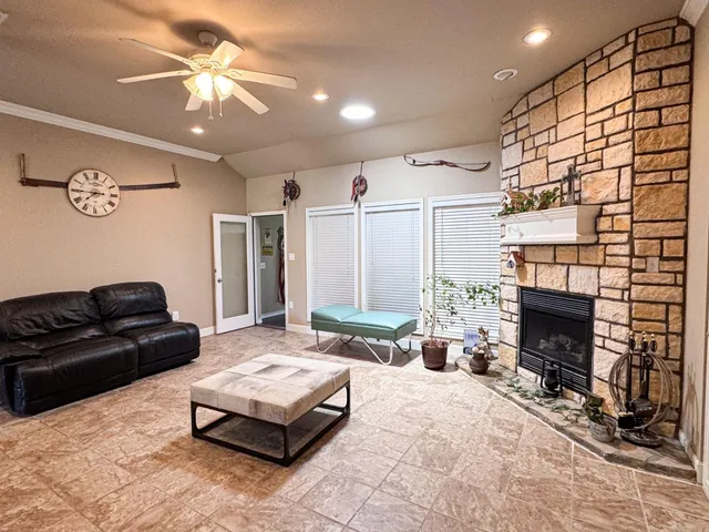 a living room with furniture and a fireplace