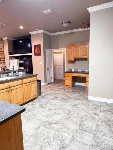 a kitchen with stainless steel appliances kitchen island granite countertop a sink and cabinets