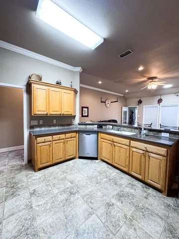 a large kitchen with stainless steel appliances and a large cabinets