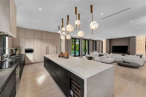 a dining room with kitchen island stainless steel appliances a table and chairs