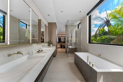 a spacious bathroom with a granite countertop tub and a large window