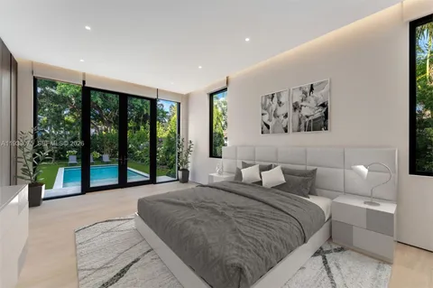 a bedroom with a large bed and a window