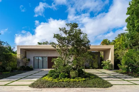 an aerial view of a house with a yard and garden