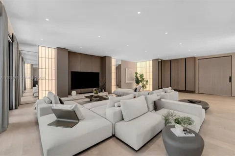 a living room with furniture flat screen tv and a large window