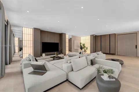 a living room with furniture flat screen tv and a large window