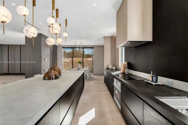 a large kitchen with kitchen island a large island in it