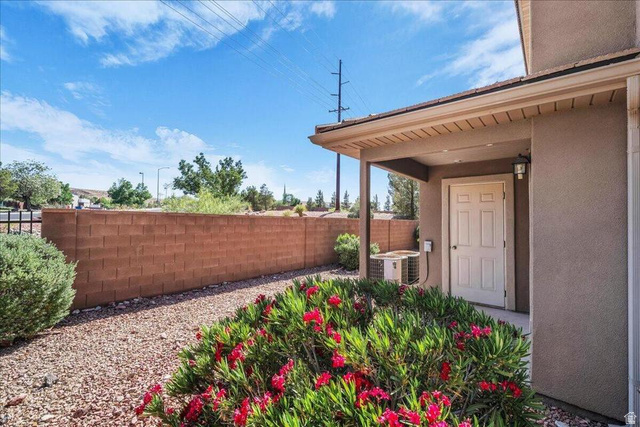 3155 South Hidden Dr Street, Unit 248 St. George, UT 84790 - Photo 18 of 24 Covered entryway with a paneled door, exterior wall lantern, and stucco finish