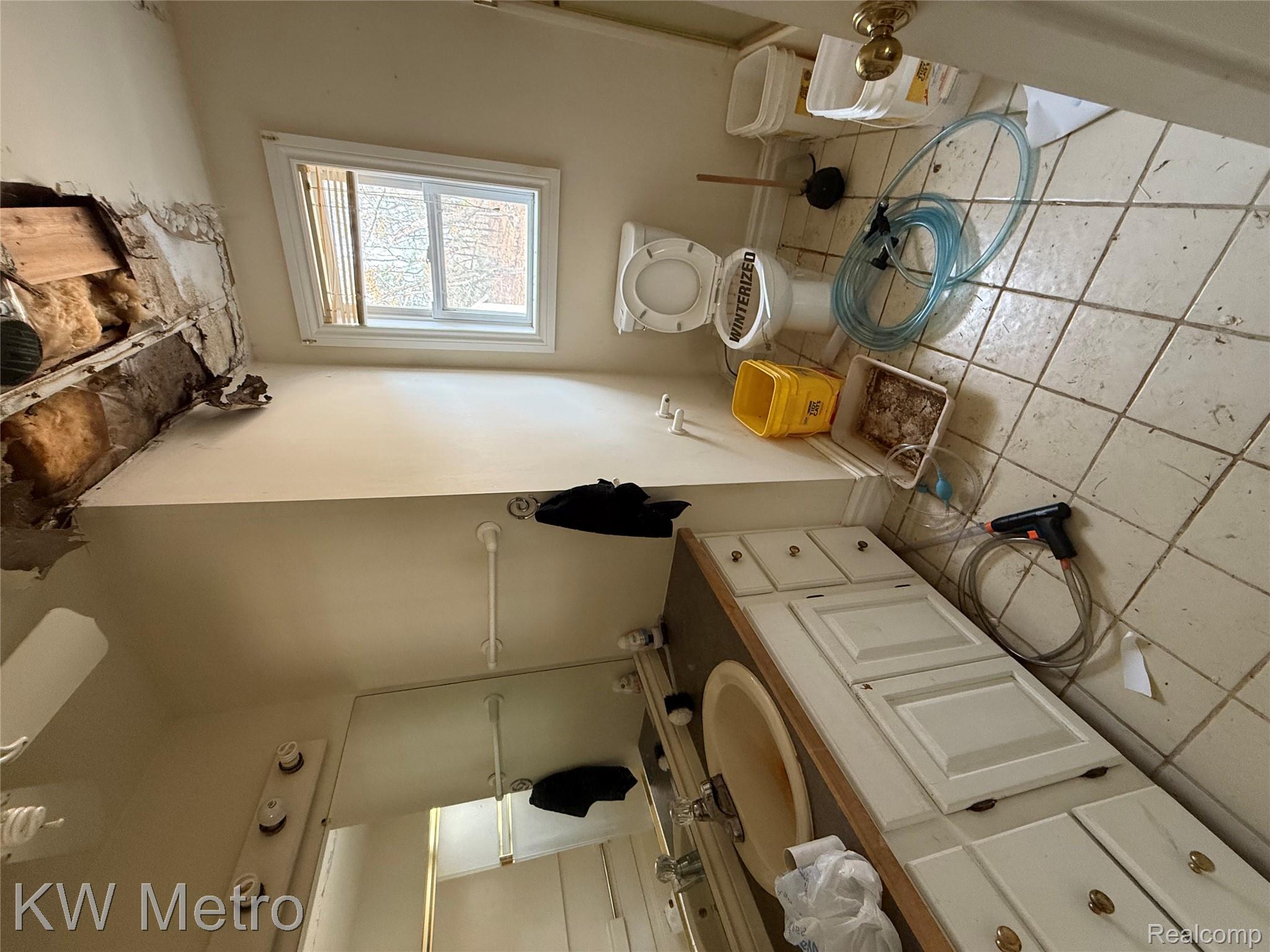 6915 Rink Drive Brighton, MI 48114 - Photo 8 of 14 Bathroom featuring vanity and light tile patterned floors