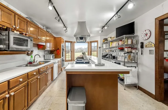 a bathroom with a sink a toilet and a large mirror