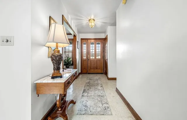 a kitchen with white cabinets and sink