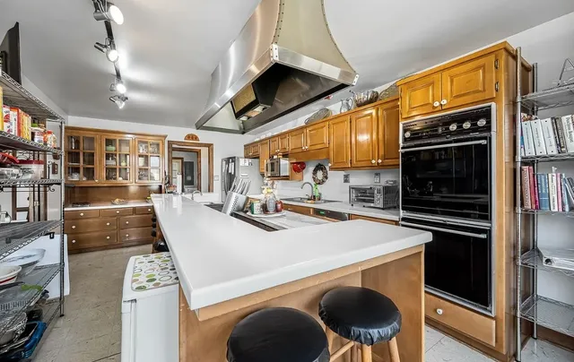 a living room with furniture a floor to ceiling window and a flat screen tv
