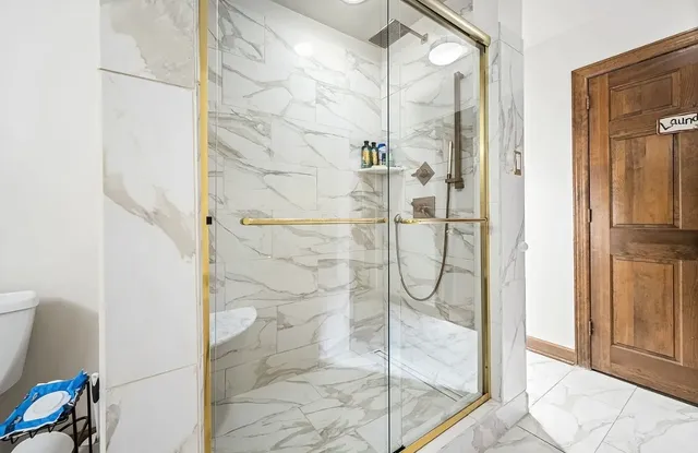 a kitchen with stainless steel appliances granite countertop a refrigerator and a stove