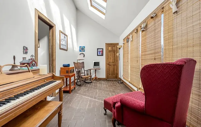 a spacious bathroom with a granite countertop sink toilet and mirror