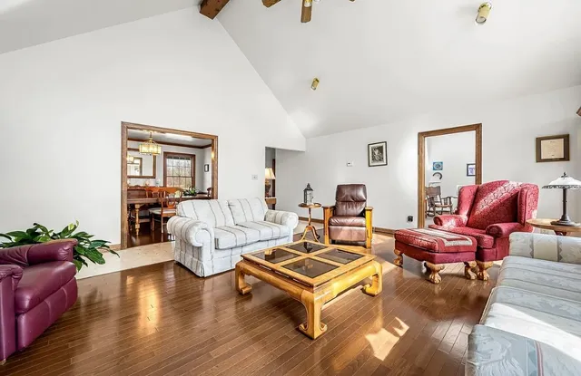 a living room with furniture a fireplace and a chandelier