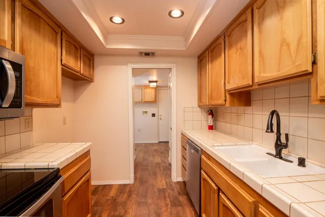 a kitchen with a sink and wooden cabinets