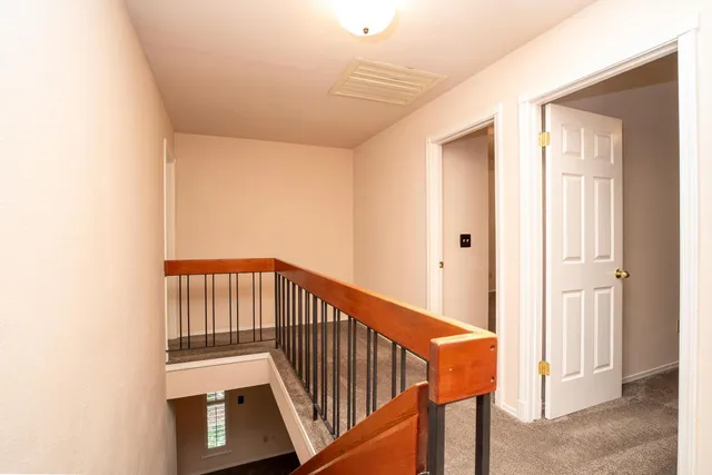 a view of a hallway with wooden floor and entryway