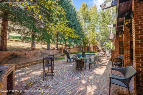 a view of a patio with table and chairs and potted plants