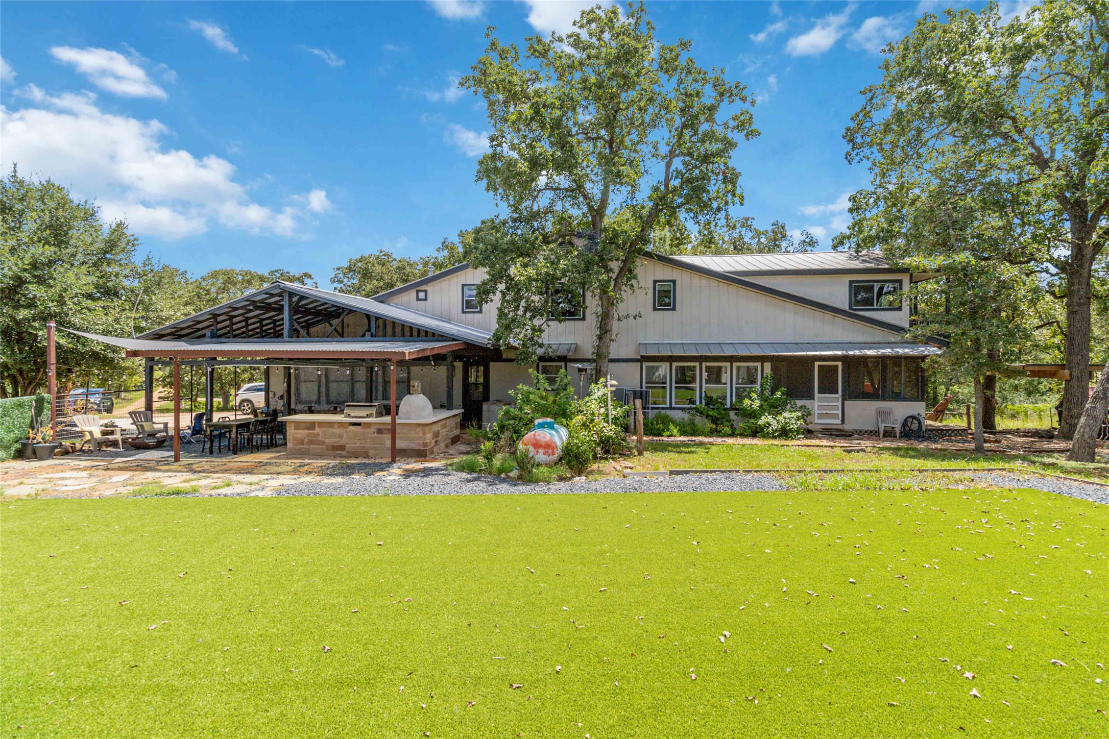 180 Ironstone Road Smithville, TX 78957 - Photo 1 of 37 a front view of a house with swimming pool and porch with furniture