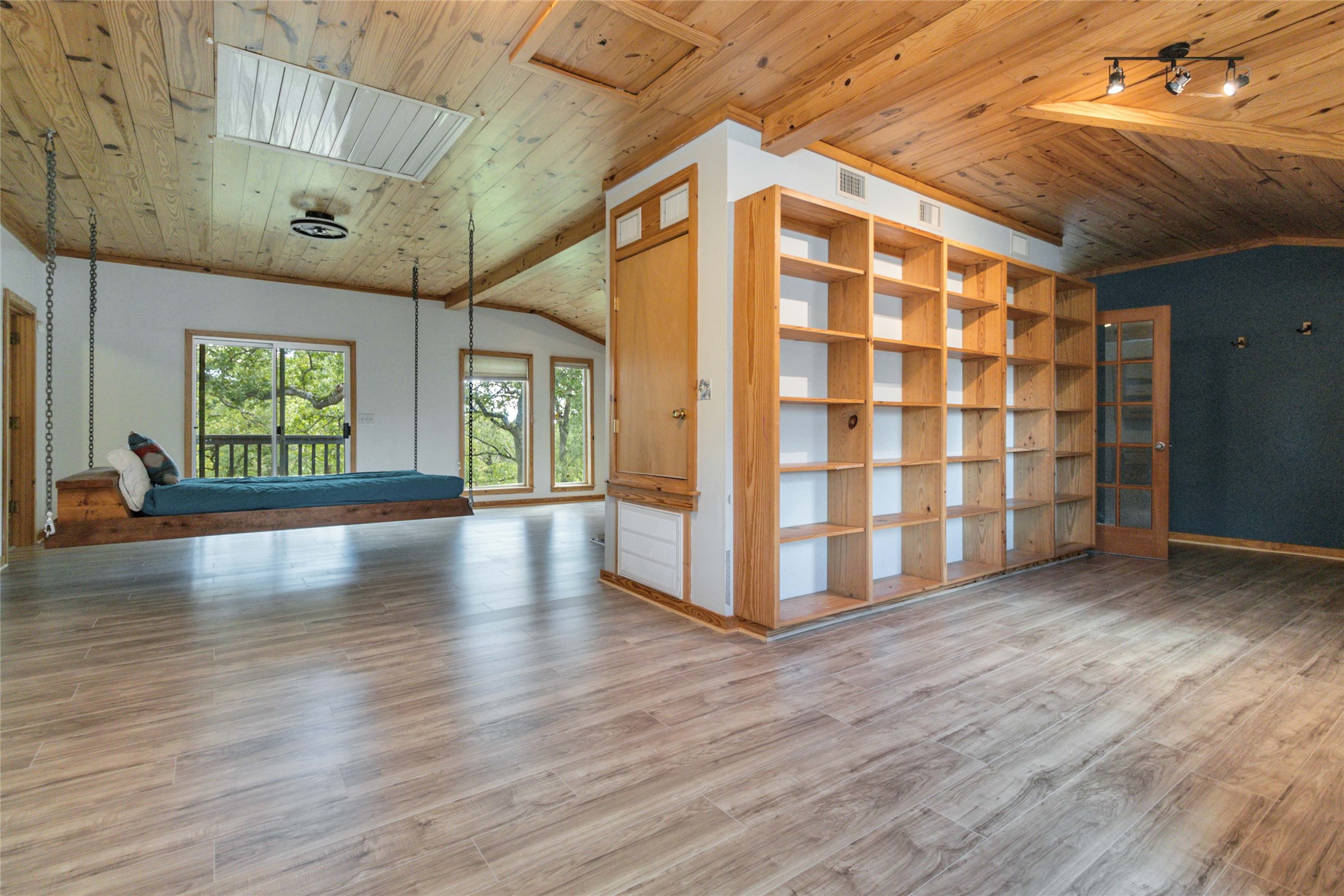 180 Ironstone Road Smithville, TX 78957 - Photo 18 of 37 a view of an empty room with a window and wooden floor