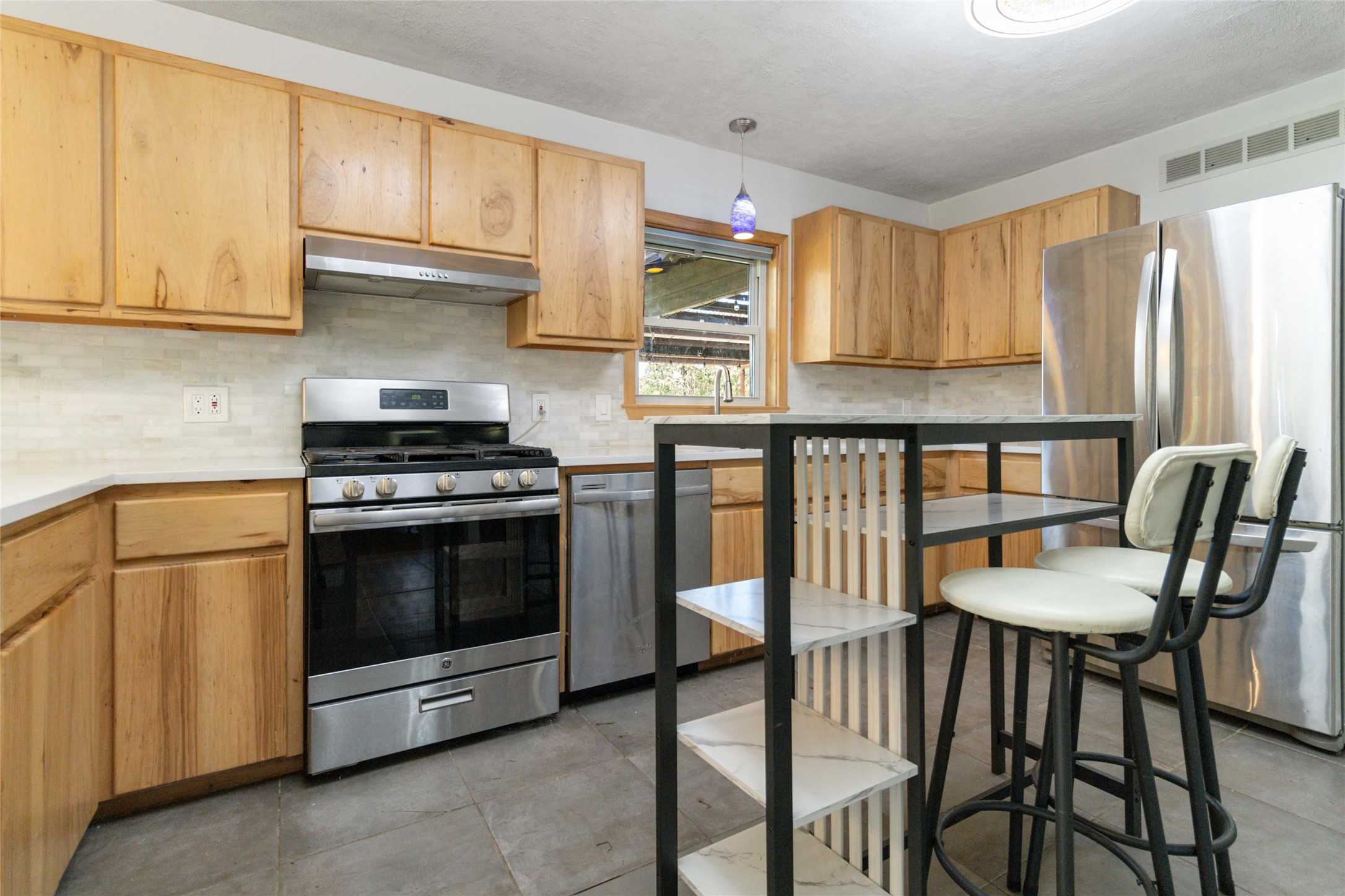 180 Ironstone Road Smithville, TX 78957 - Photo 28 of 37 a kitchen with stainless steel appliances granite countertop a stove a sink dishwasher and cabinets with wooden floor