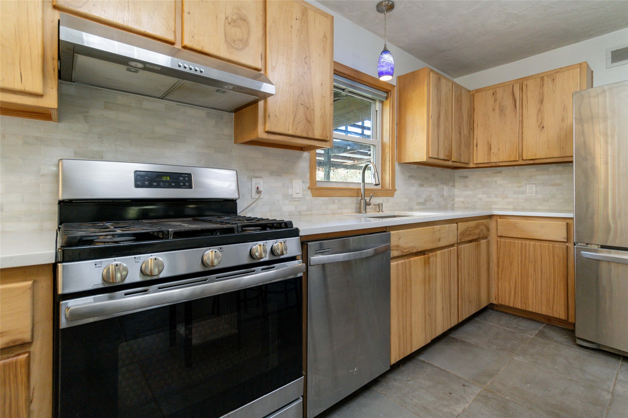 180 Ironstone Road Smithville, TX 78957 - Photo 29 of 37 a kitchen with a sink stove and cabinets