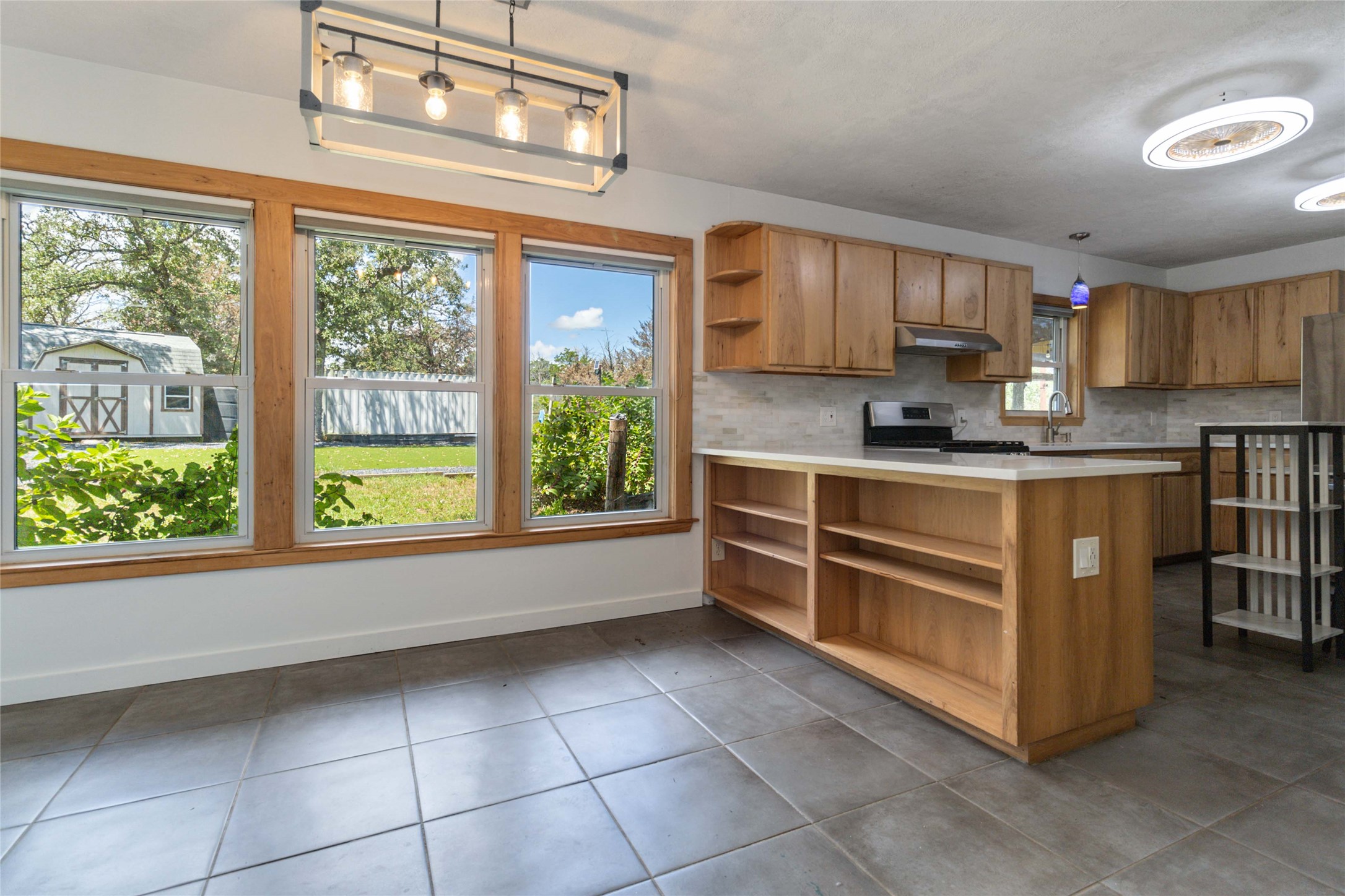 180 Ironstone Road Smithville, TX 78957 - Photo 32 of 37 a kitchen with stainless steel appliances a stove sink and cabinets