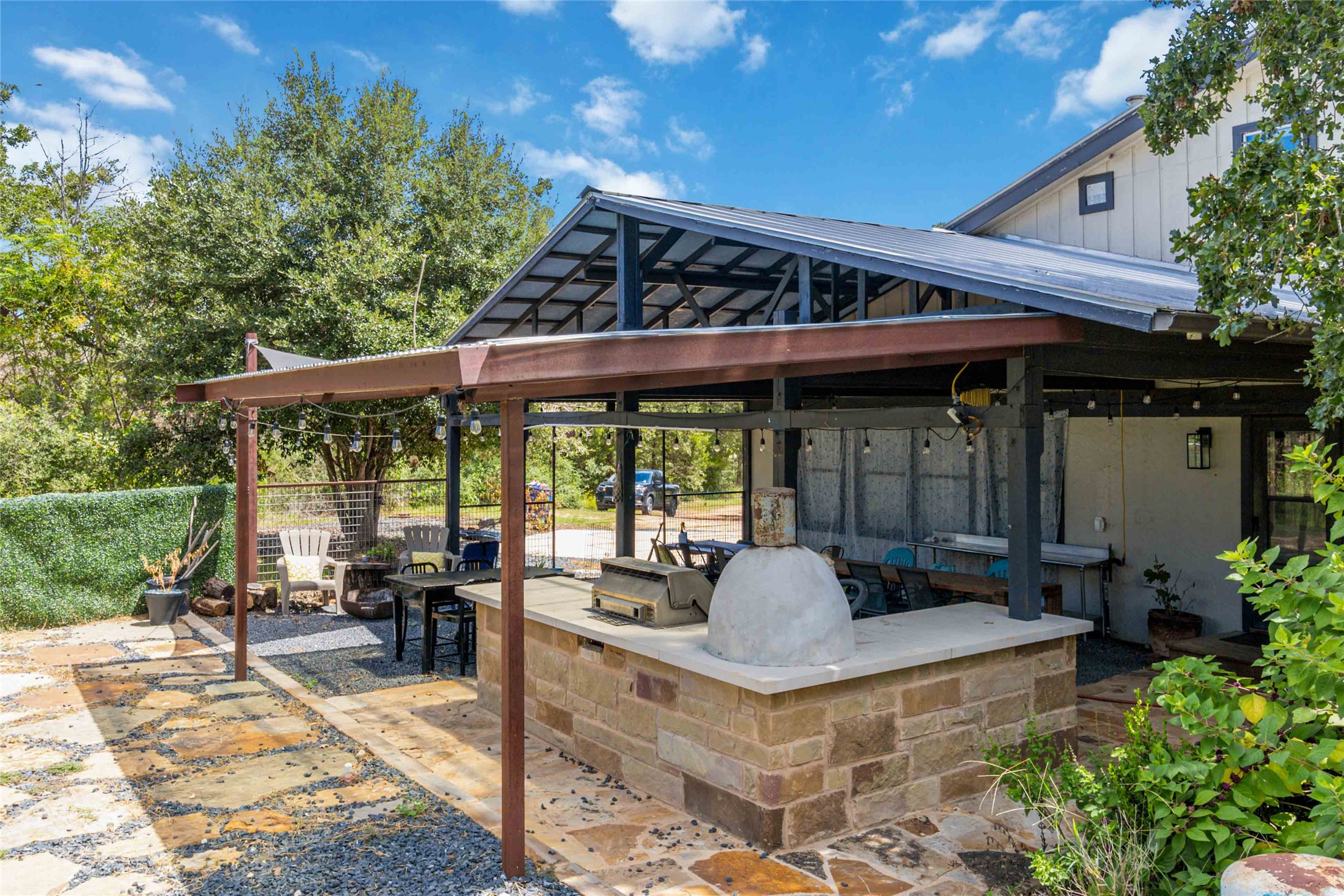 180 Ironstone Road Smithville, TX 78957 - Photo 36 of 37 a view of a patio with table and chairs potted plants and floor to ceiling window