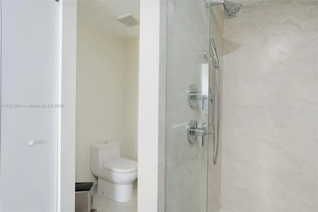 a bathroom with a granite countertop toilet