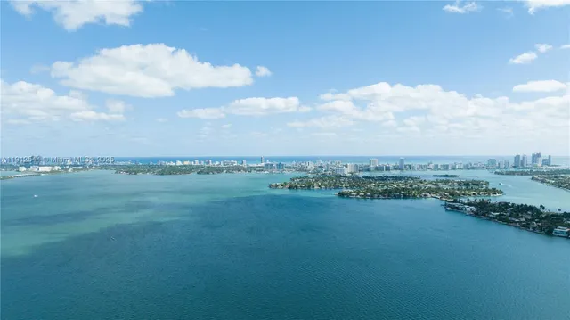 a view of a lake with houses in the back