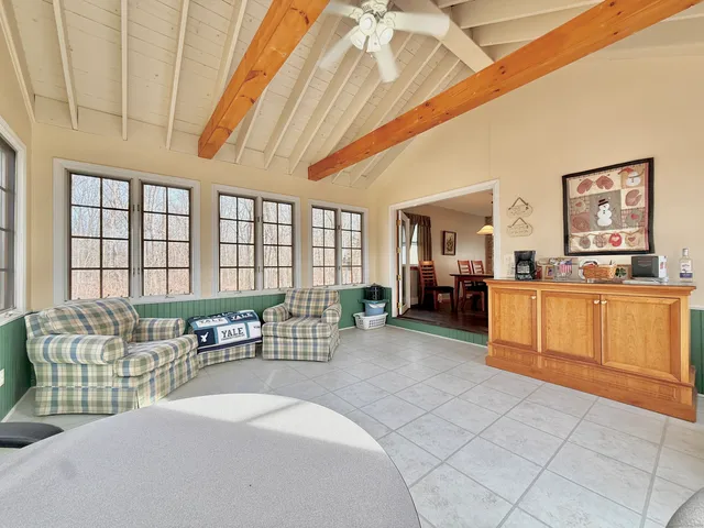 a spacious bedroom with a bed and a large window