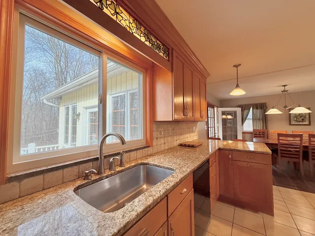 a kitchen with granite countertop a sink and a counter top space