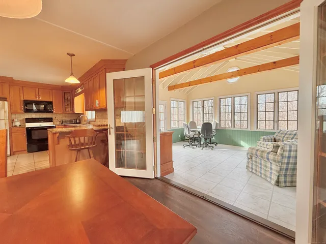 a living room with furniture a wooden floor and a large window