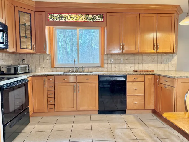 a kitchen with stainless steel appliances granite countertop a stove and a cabinets