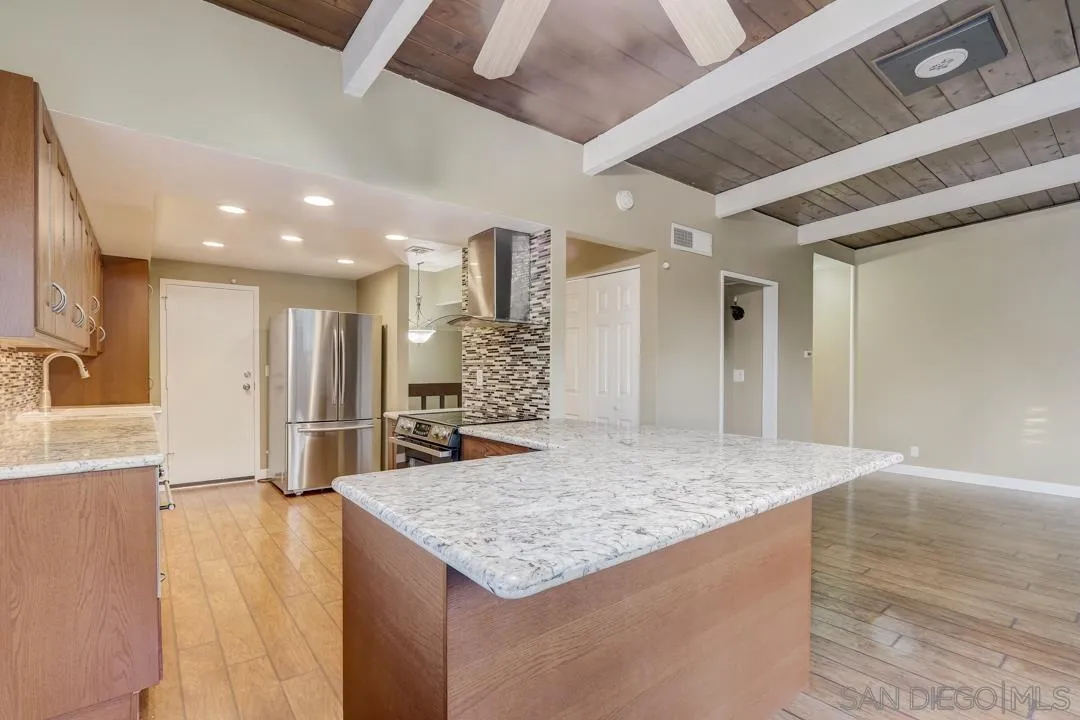 6395 Rancho Mission Road, Unit 15 San Diego, CA 92108 - Photo 11 of 21 a large kitchen with kitchen island a sink stainless steel appliances and cabinets
